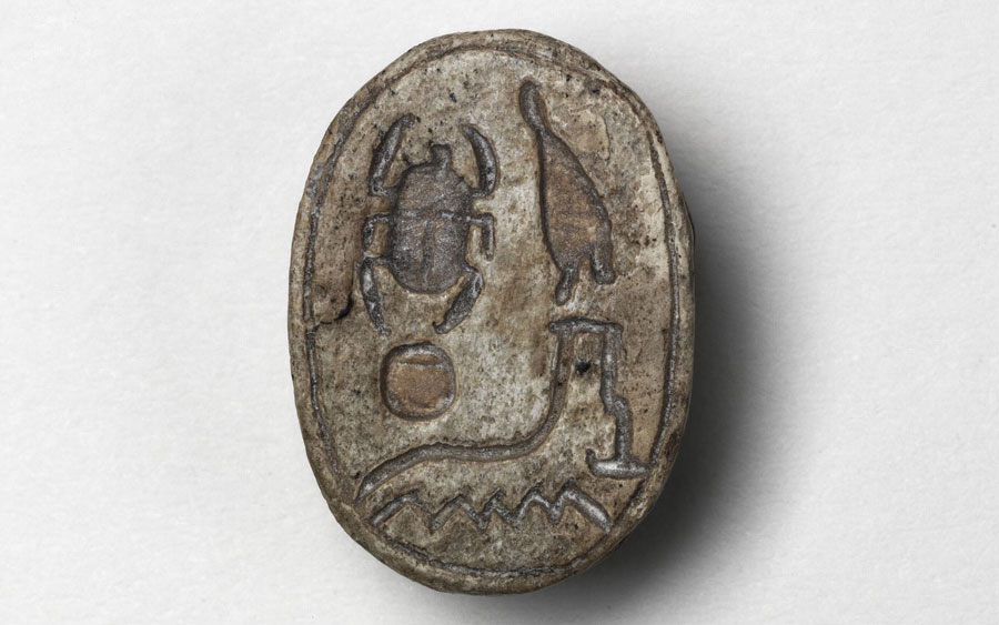 Steatite scarab with inscription.