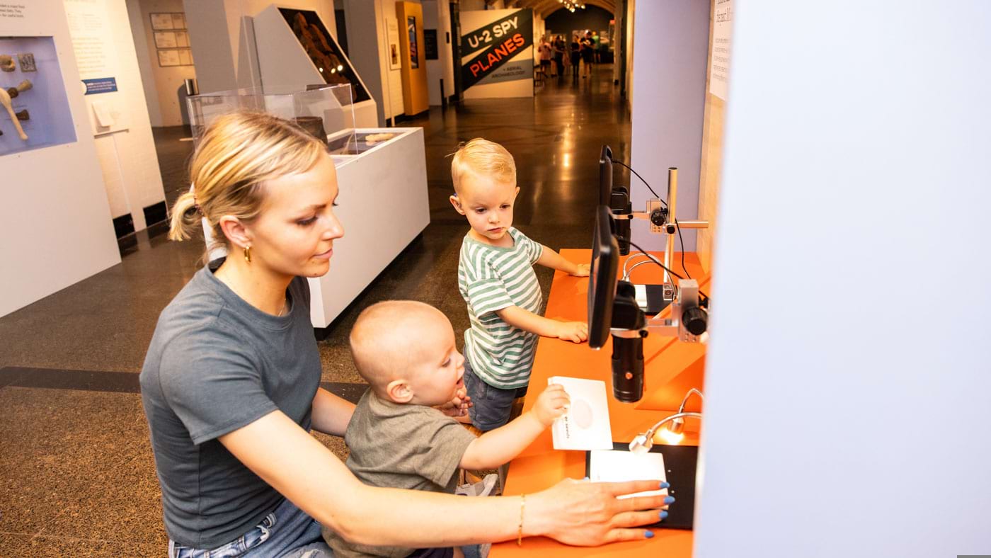 A family using an interactive from the Spy Planes exhibit.