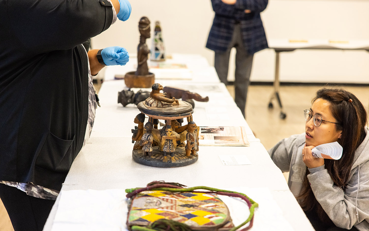 Museum guests looking at a selection of artifacts.